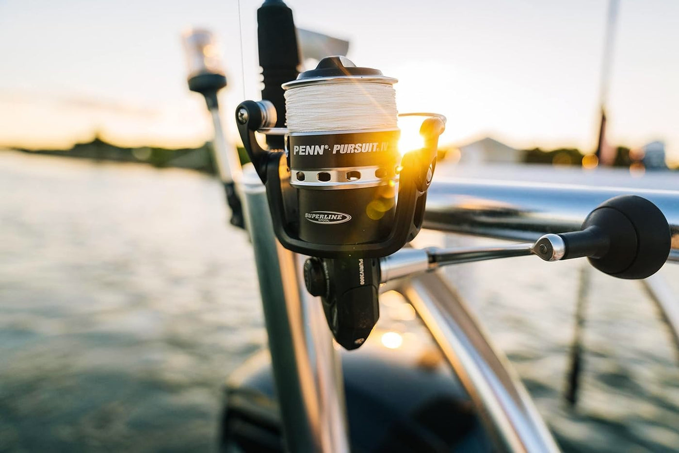 Angled view of PENN Pursuit IV spinning reel attached to the fishing rod, highlighting its durability