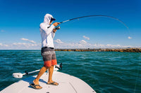 Angled view of PENN Pursuit IV spinning reel attached to the fishing rod, highlighting its durability.